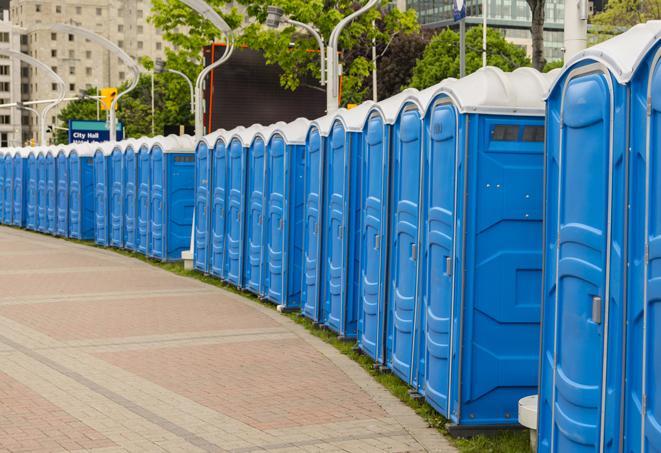 a row of portable restrooms at an outdoor special event, ready for use in Brooklyn Center